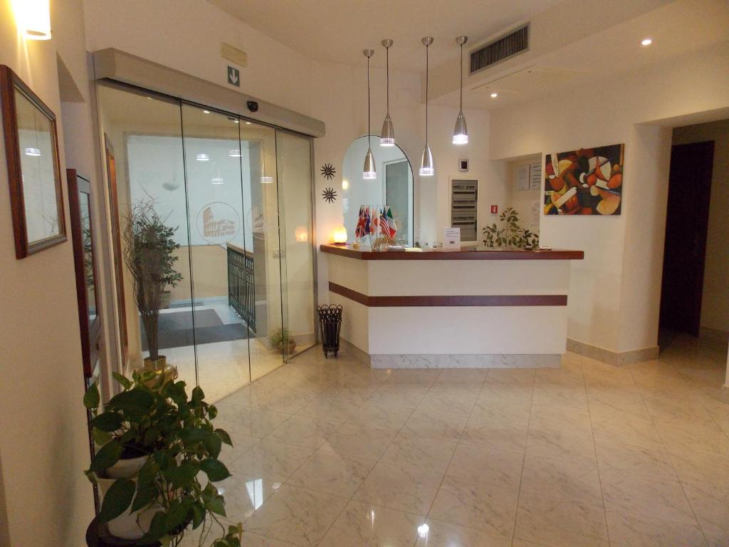a lobby with a counter in a building at Albergo Roma in Matera