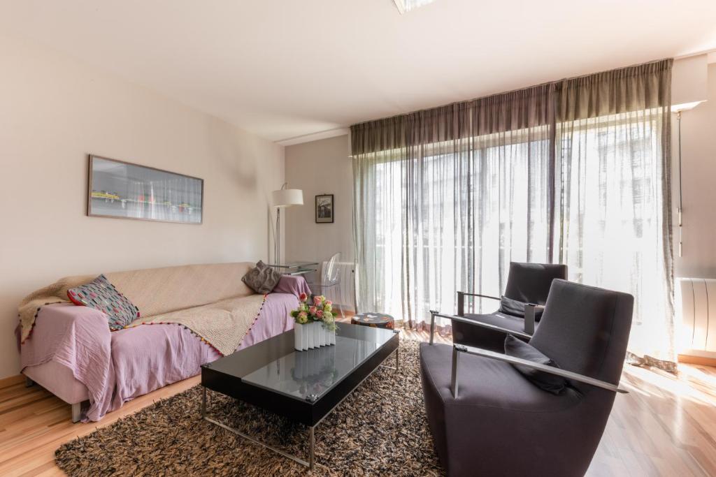 a living room with a couch and a table at Les Terrasses du Palais in Vannes