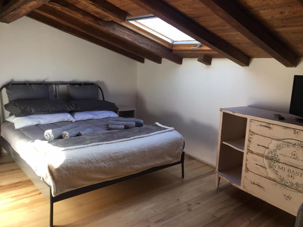 a bedroom with a bed and a dresser with a television at Terra della Baronia in Santo Stefano di Sessanio