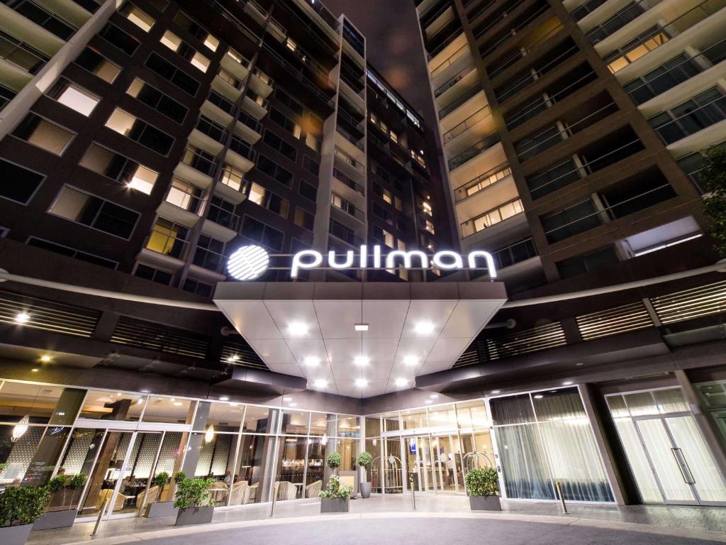 
a large building with a sign on the side of it at Pullman Adelaide in Adelaide
