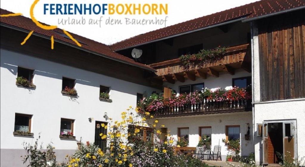 a building with flower boxes on the balconies at Woferlhof, Ferienhof Boxhorn in Böbrach