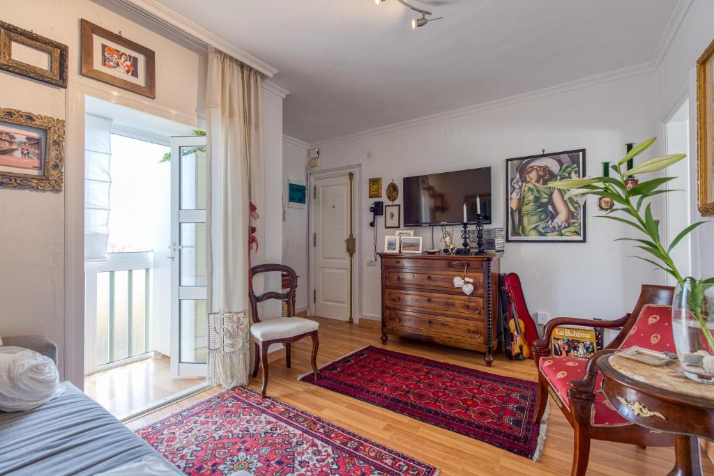 a living room with a bed and a table and chairs at Orchidea Home in Las Palmas de Gran Canaria