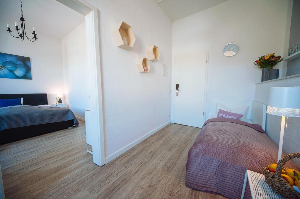 a small bedroom with a bed and a room with a bed at Apartmenthaus Kaiser Friedrich in Potsdam