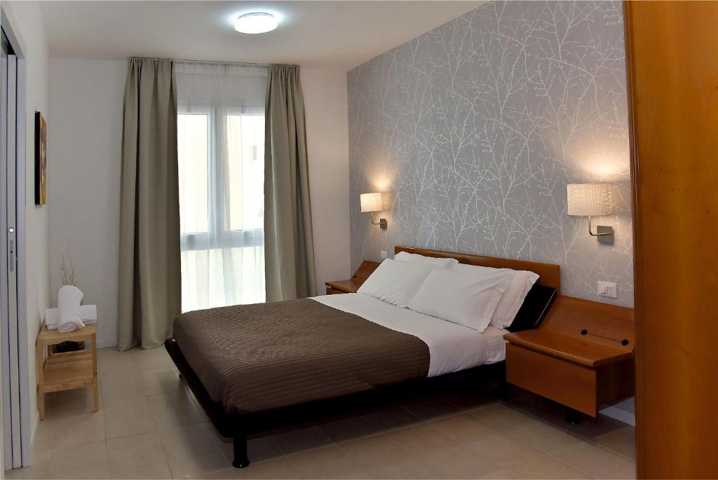 Posteľ alebo postele v izbe v ubytovaní Garda Bloom Holiday Apartments