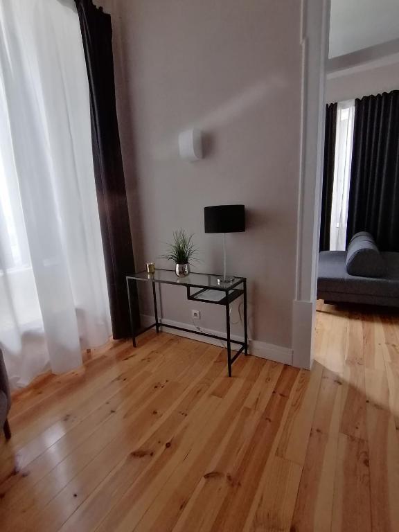 a living room with a table and a couch at Temple Suites Guesthouse in Portimão