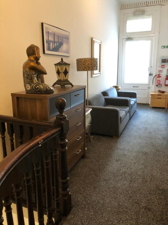 a living room with a staircase and a couch at Renfrew rooms at City Centre in Glasgow