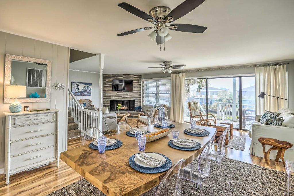 a living room with a dining table and a ceiling fan at Waterfront Home with Decks, Privacy and Boat Slip in Holden Beach