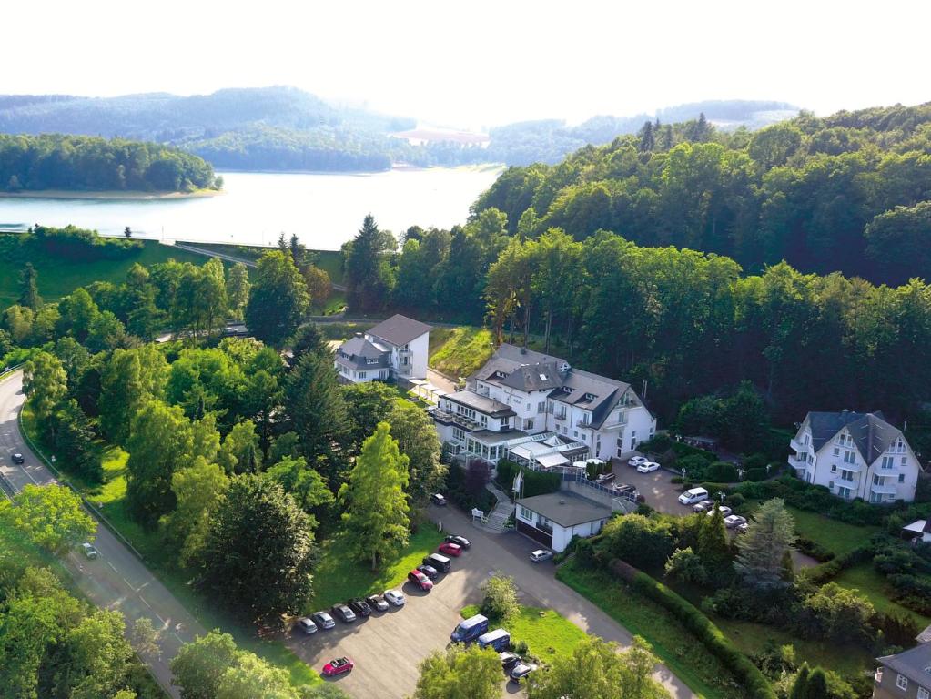 an aerial view of a large house with a parking lot at Hennedamm Hotel in Meschede