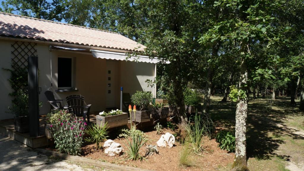 a garden in front of a house with plants at Clos l&#39;Oustal in Labastide-de-Virac