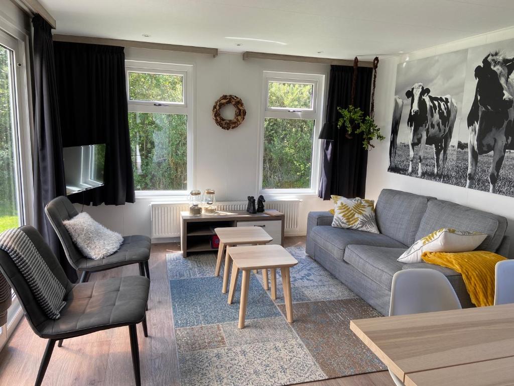 a living room with a couch and a table at olmenduin 33 in Serooskerke