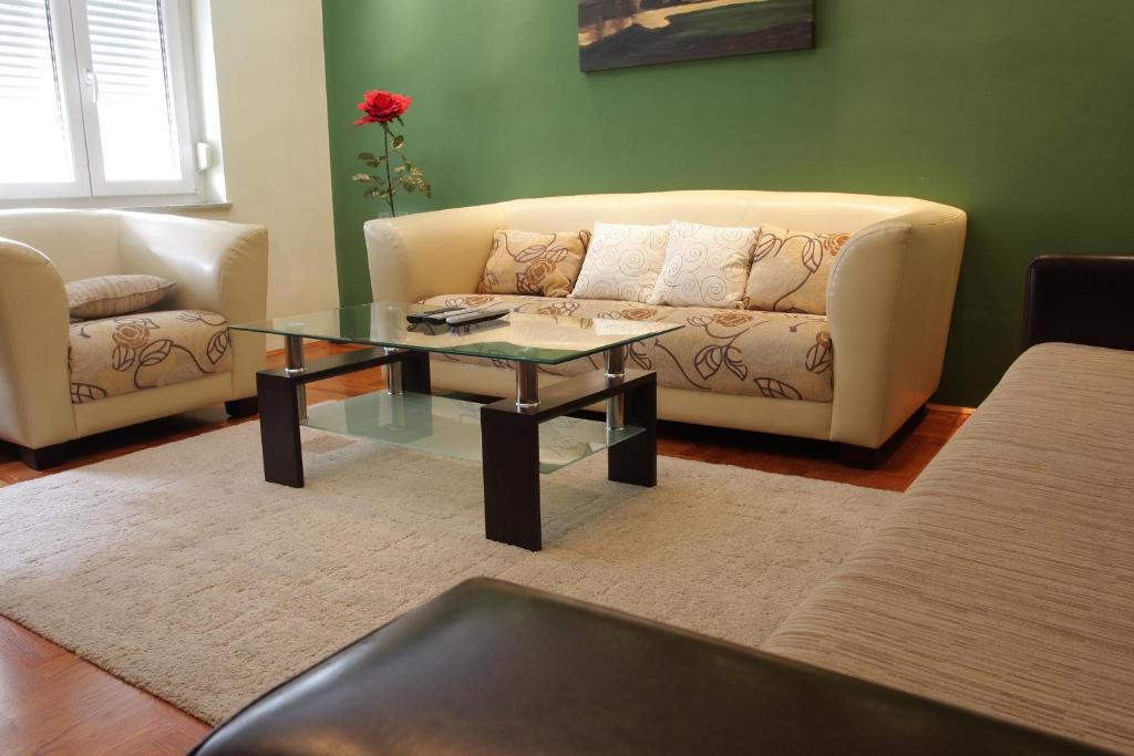 a living room with a couch and a coffee table at Apartments AS - Zagreb Centre in Zagreb