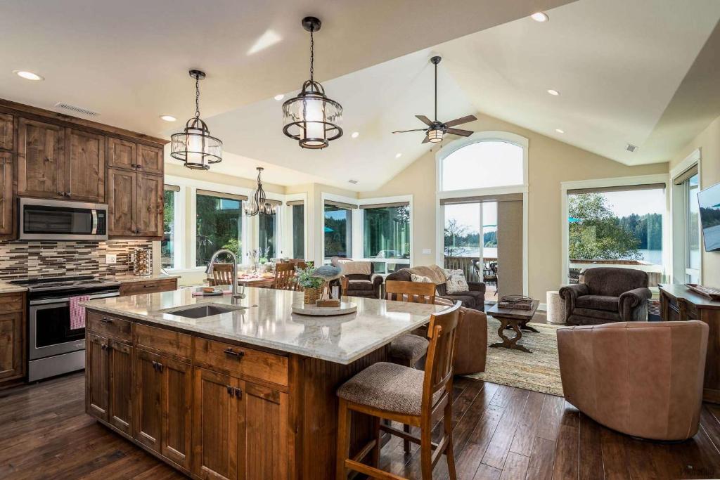 a kitchen with a large island and a living room at Siltcoos Landing in Florence