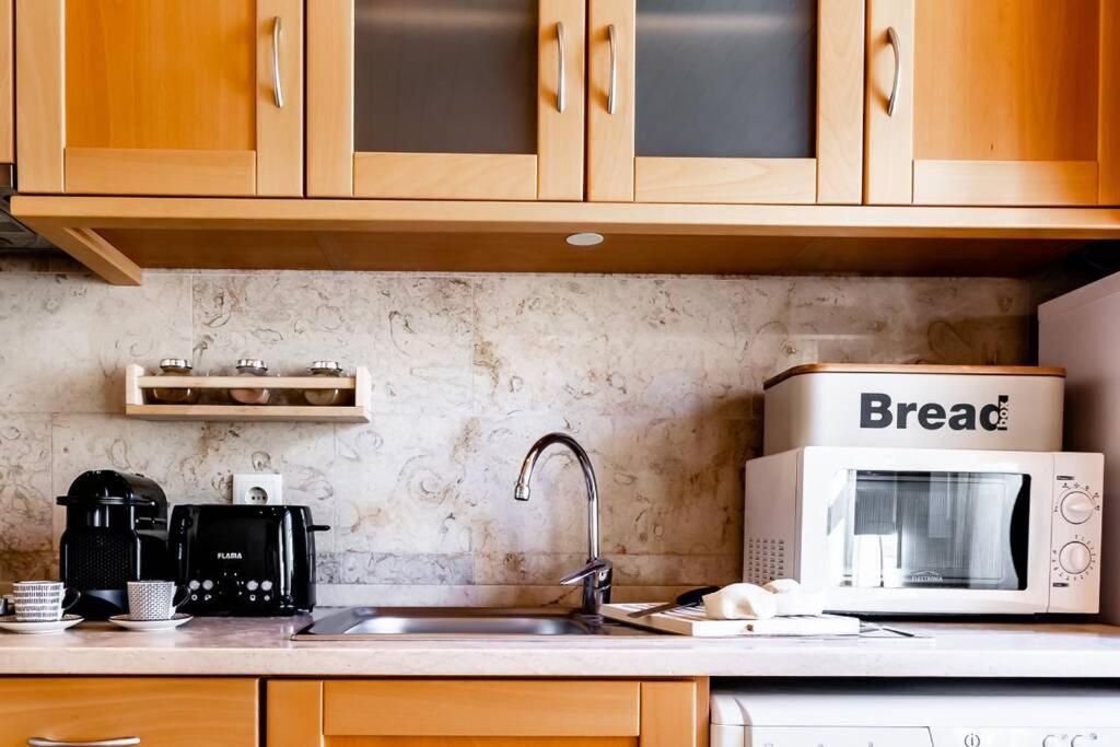 a kitchen with a sink and a microwave at InLoveApartments - Duplex at Alfama in Lisbon