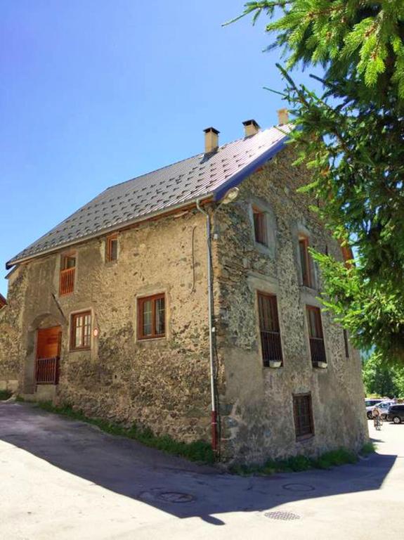 an old stone building with a metal roof at Appartement de 4 chambres avec jardin clos et wifi a Le Monetier les Bains in Le Monêtier-les-Bains