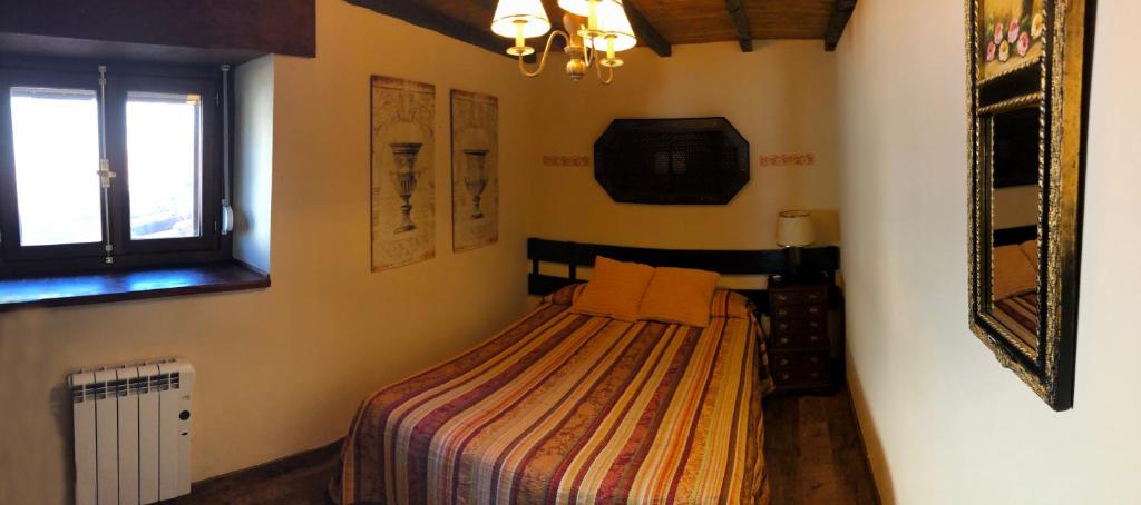 a small bedroom with a bed in a room at Gran Pedroso de Llanes in Llanes