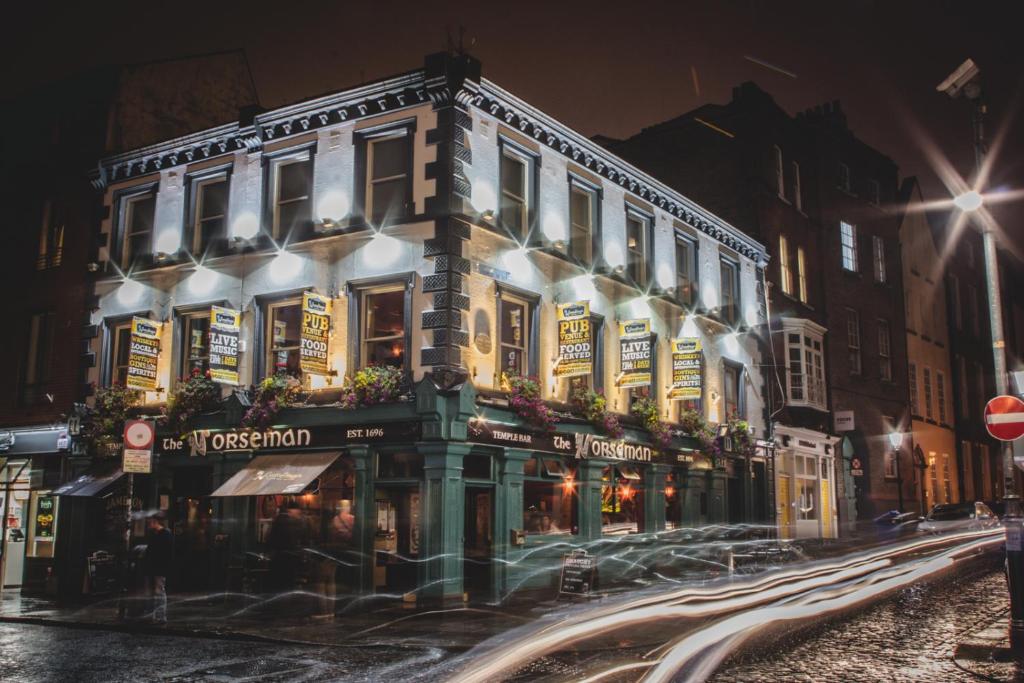 a building on a city street at night at The Norseman Temple Bar in Dublin