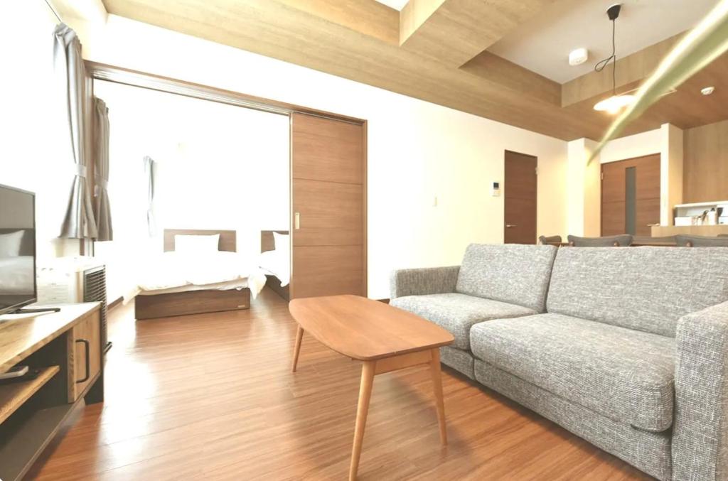 a living room with a couch and a table at Hills Garden Hondori / Vacation STAY 7577 in Sapporo