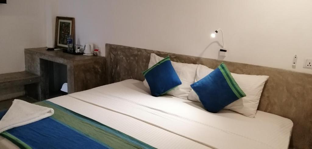 Postel nebo postele na pokoji v ubytování Kutumbaya