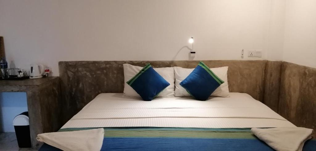 Postel nebo postele na pokoji v ubytování Kutumbaya