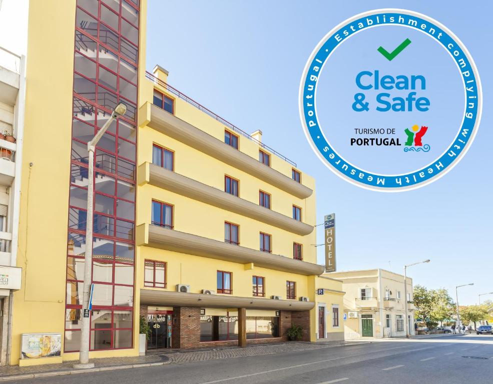 a building with a sign that says clean and safe at Best Western Hotel Dom Bernardo in Faro