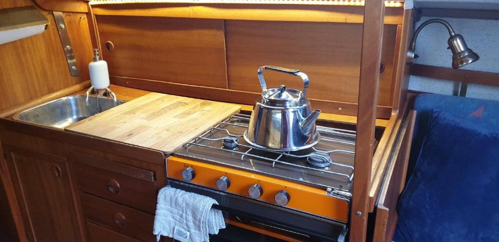a kitchen with a tea kettle on a stove at Sailboat Chanel in Karlshamn