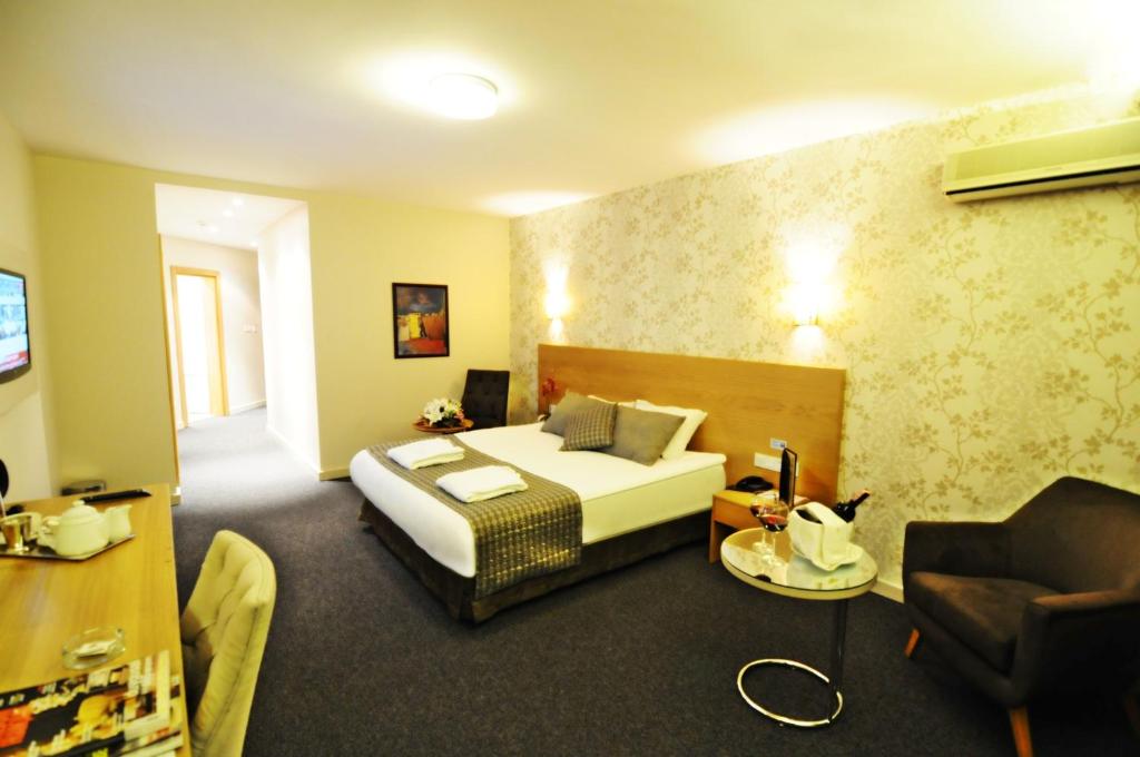 a hotel room with a bed and a couch at Silivri Park Hotel in Silivri