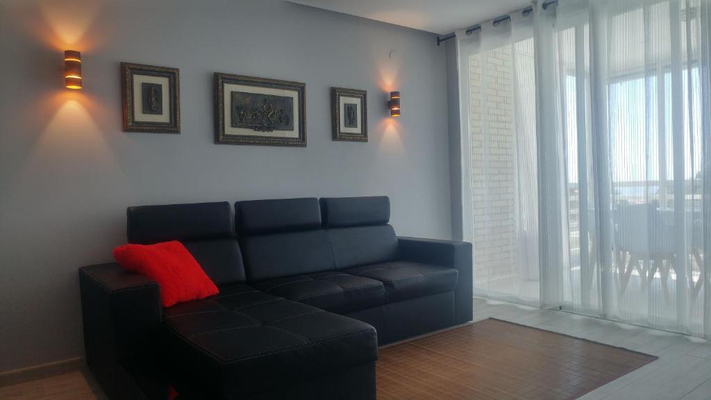 A seating area at Aster Apartamento