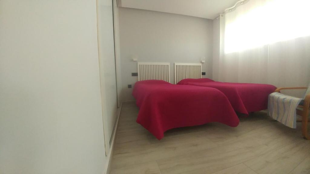 A bed or beds in a room at Aster Apartamento