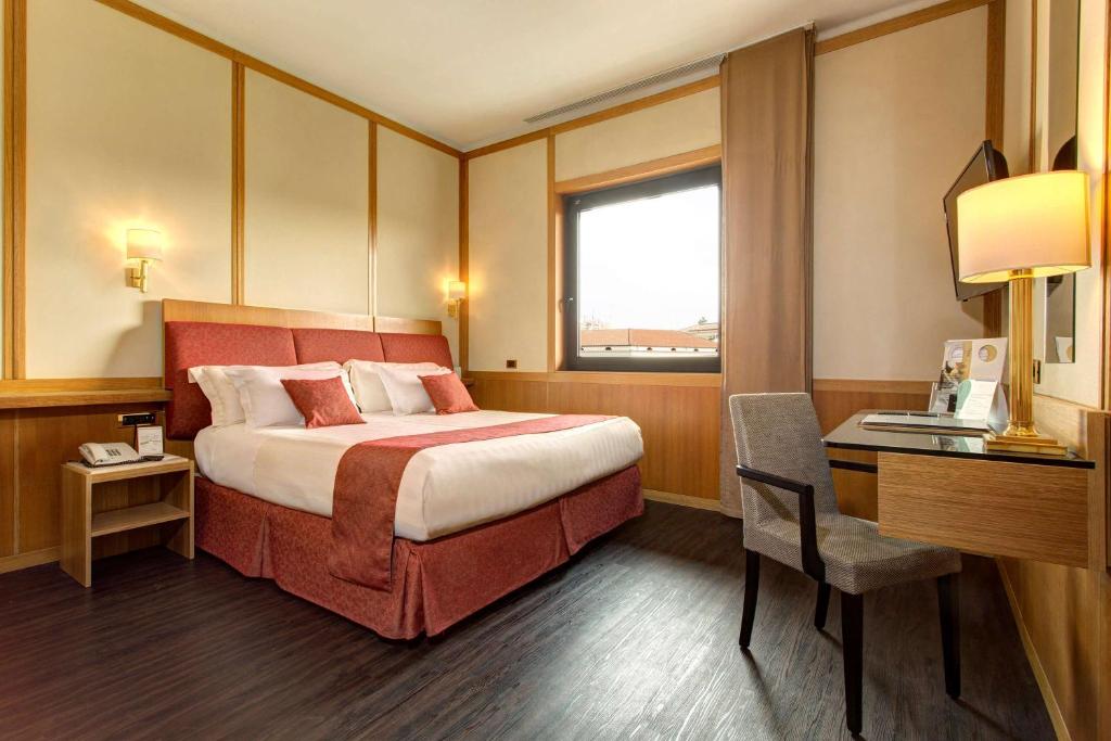 Un pat sau paturi într-o cameră la Best Western Hotel President - Colosseo