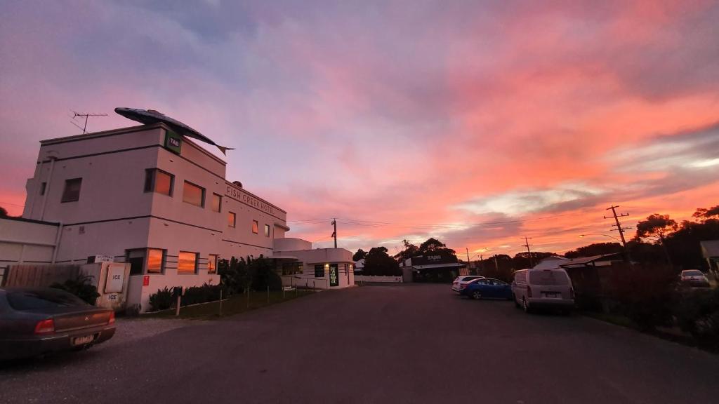 a building with a sunset in the background at Fish Creek Hotel in Fish Creek