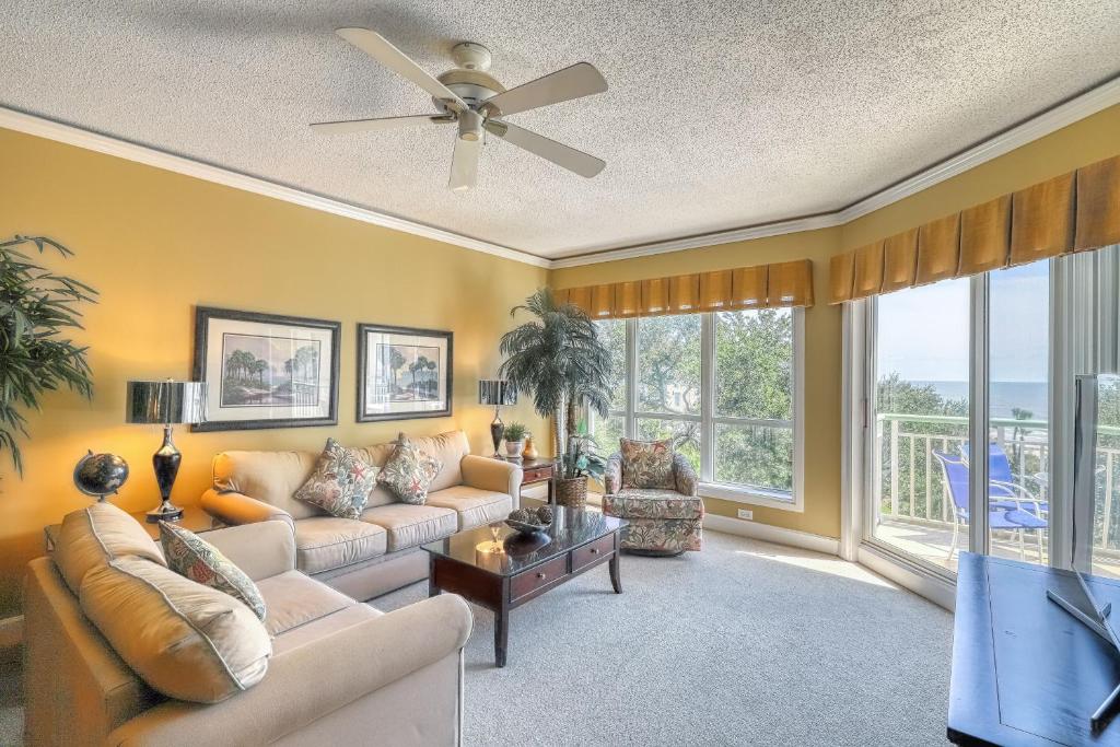 a living room with a couch and a ceiling fan at Windsor II in Hilton Head Island