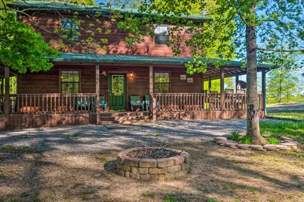 a log cabin with a porch and a tree at Lake House with Hot Tub and Fire Pit - 1 Mi to Marina! in Frogue