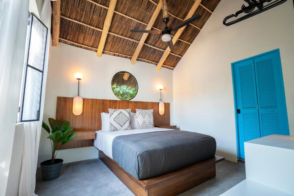 a bedroom with a bed and a blue door at Casa Pia in Sayulita
