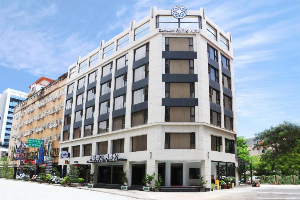 a building with a clock on the top of it at Gamalan Spring Hotel in Jiaoxi