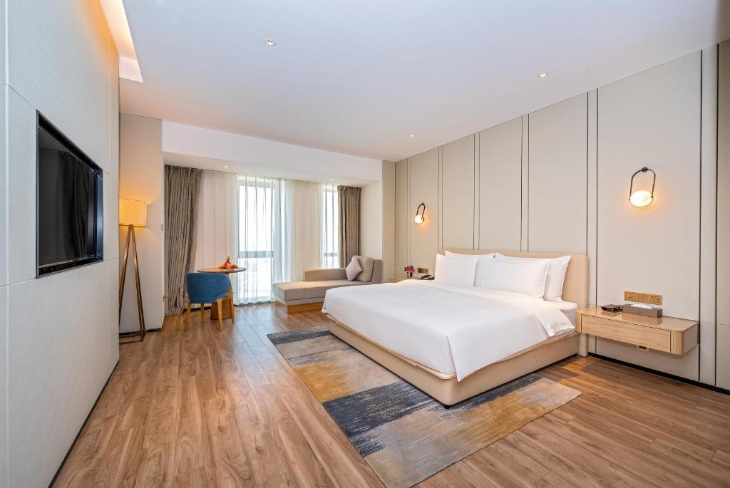 Postel nebo postele na pokoji v ubytování Nanan Ao Sheng Yi Hao Hotel