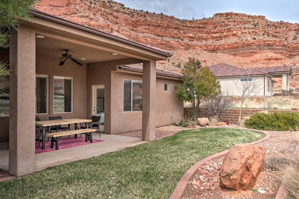 a house with a picnic table and a mountain at Bright Modern Abode - 32 Miles to Zion Natl Park! in Kanab