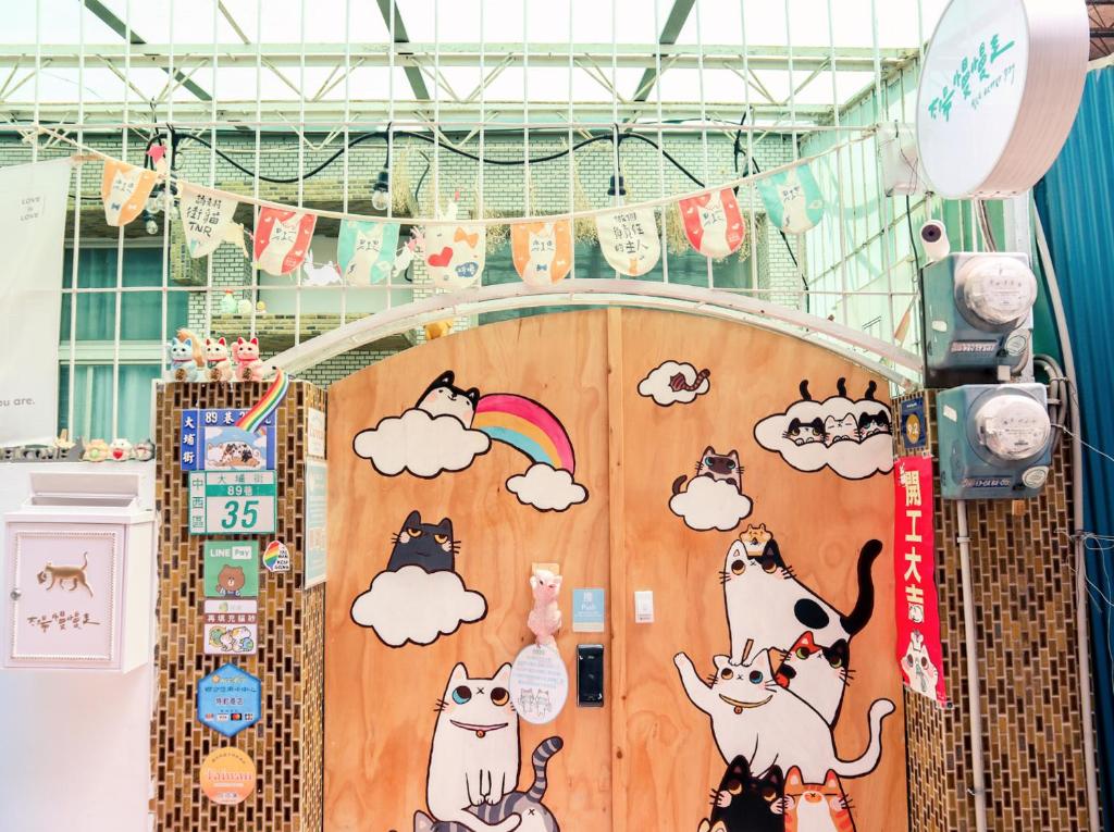 a room with a door with cats on it at Red Letter Day in Tainan