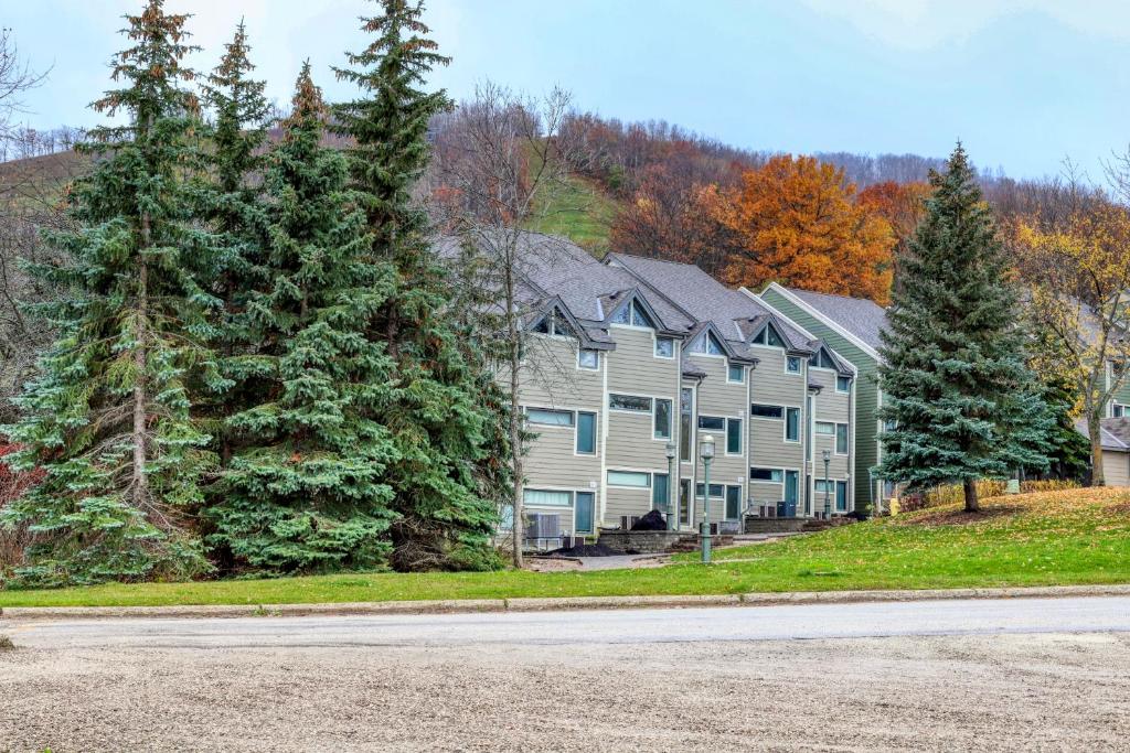 a large house with trees on the side of a road at Chateau Ridge in Blue Mountains