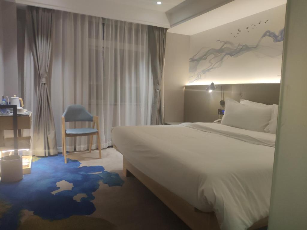 Postel nebo postele na pokoji v ubytování Shenzhen Yanan Hotel