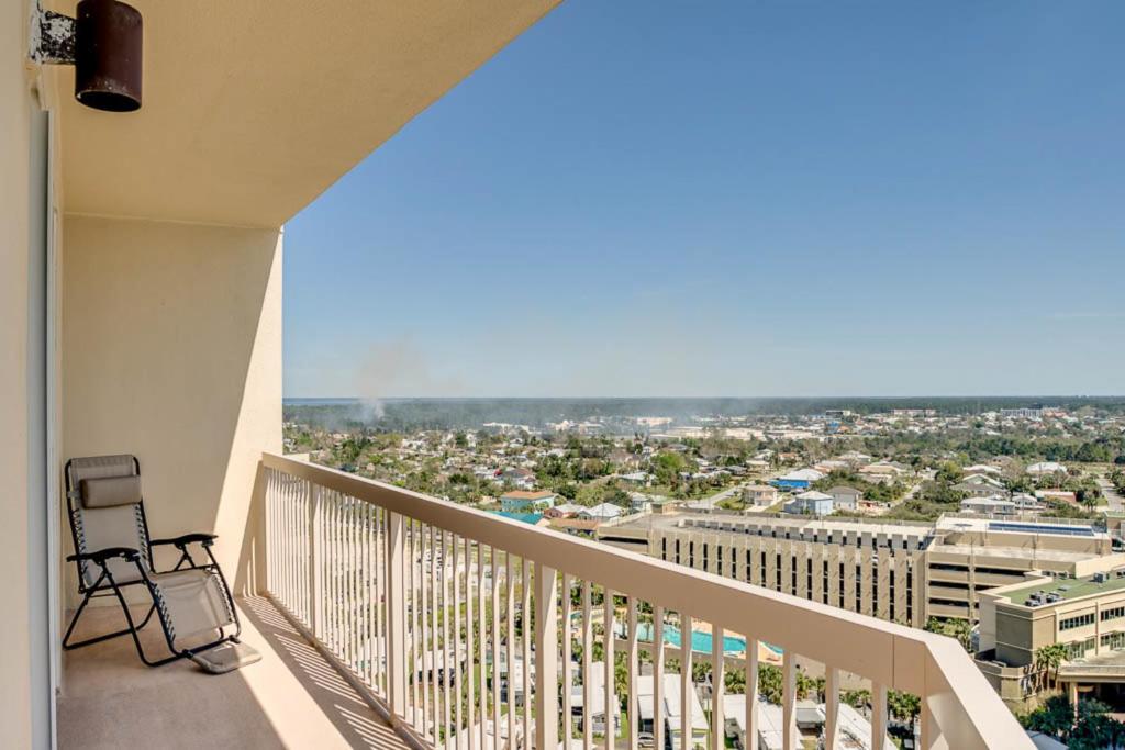a balcony with a chair and a view of a city at Sunrise Beach Resort II in Panama City Beach