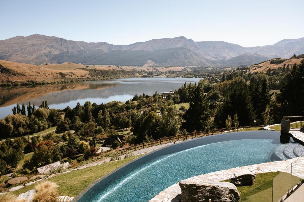 a swimming pool with a view of a lake at Stoneridge Estate in Queenstown
