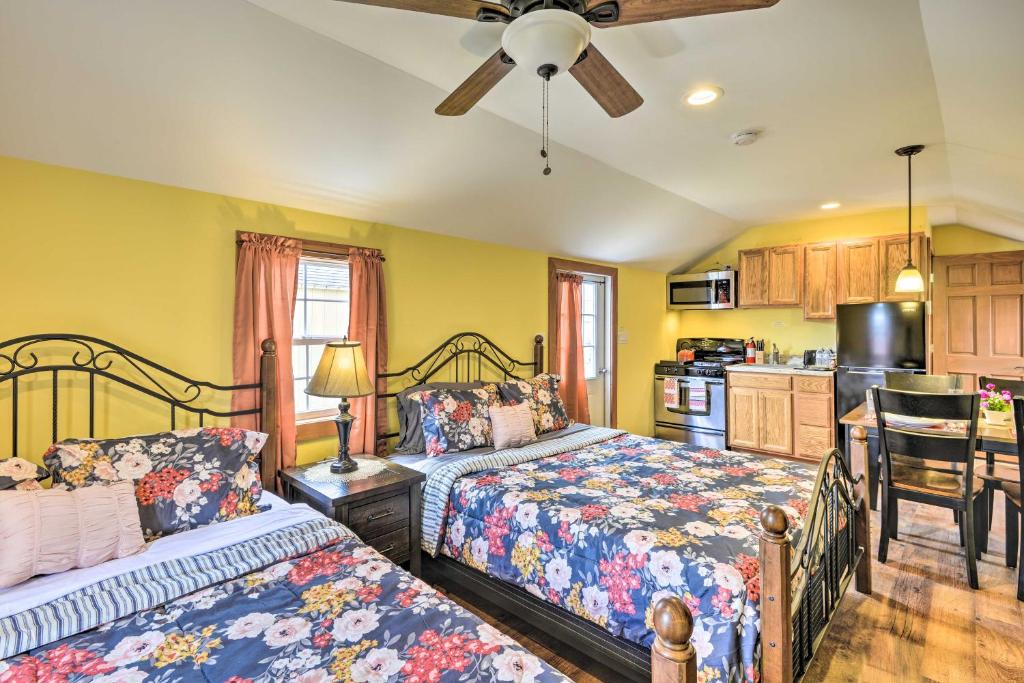 a bedroom with two beds and a kitchen at Pet-Friendly Poconos Abode - Pool, Pond and Fire Pit in Pleasant Mount