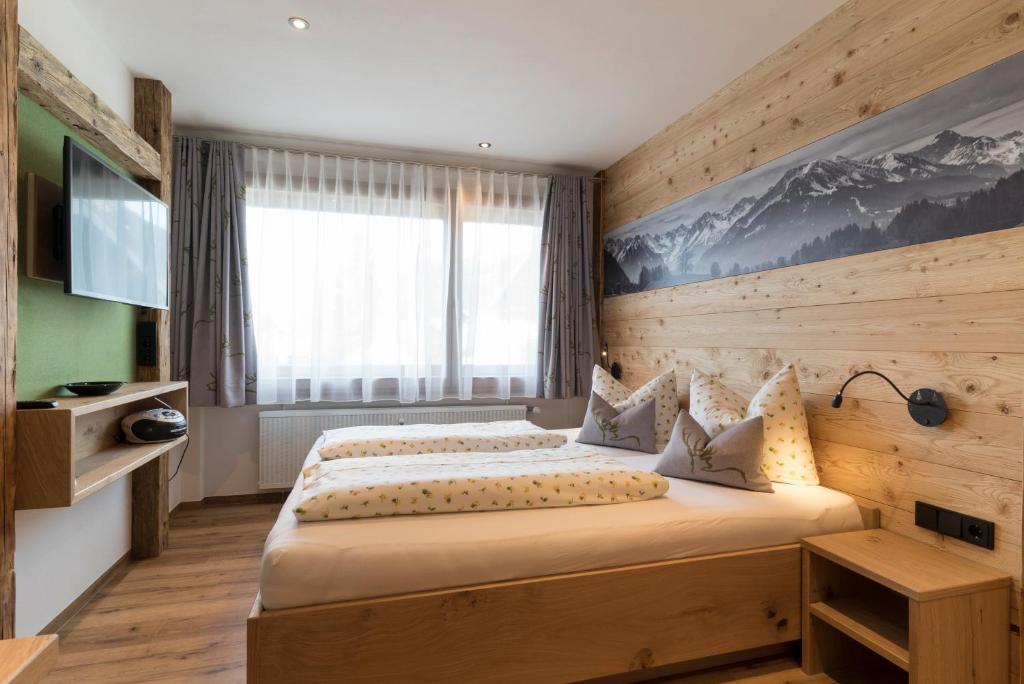 een slaapkamer met een groot bed en een raam bij Ferienwohnung Paulus in Oberstdorf