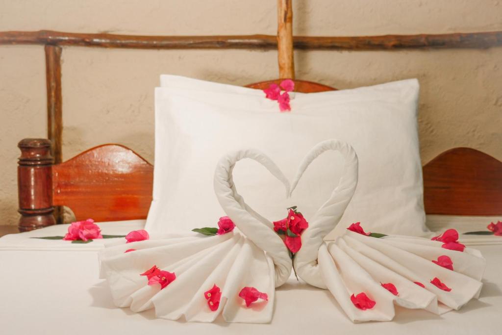 a white wedding cake with two swans made out of fondant at Demani Lodge Zanzibar in Paje