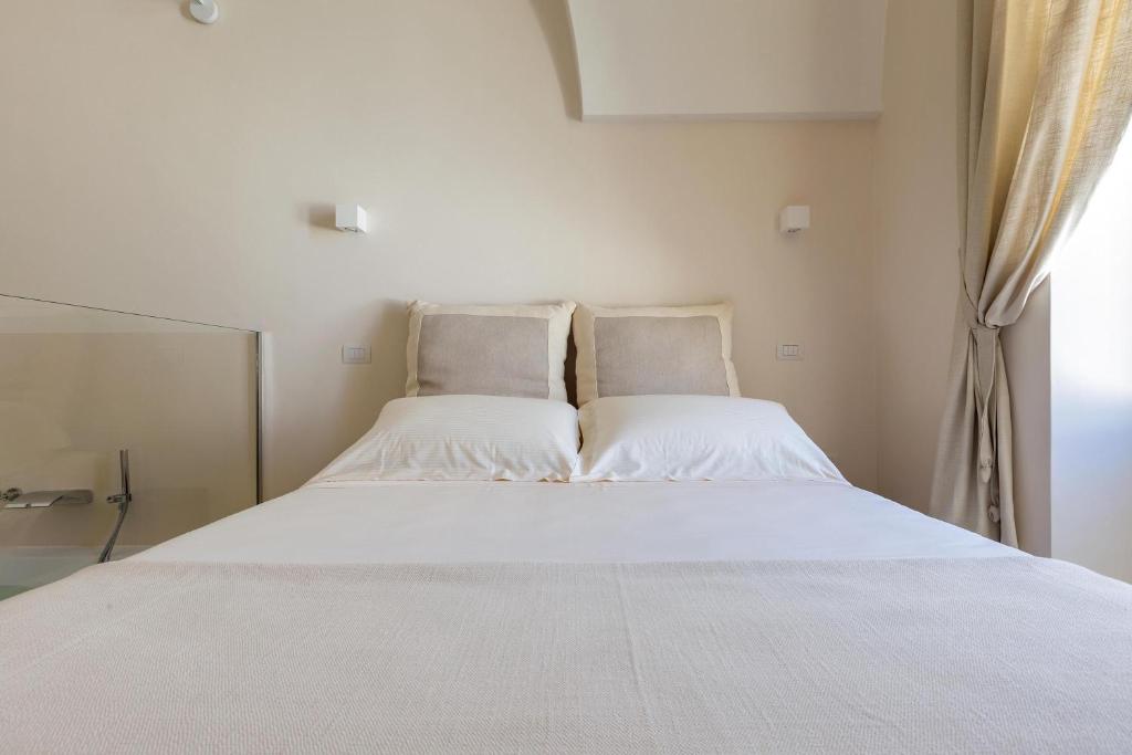 Postel nebo postele na pokoji v ubytování Palazzo Mascetti