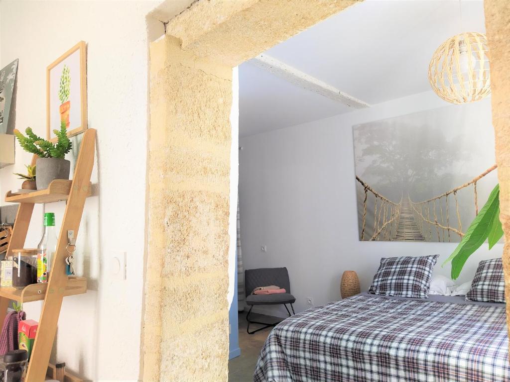 a bedroom with a bed and a bridge painting on the wall at le balcon de Saint Roch in Montpellier