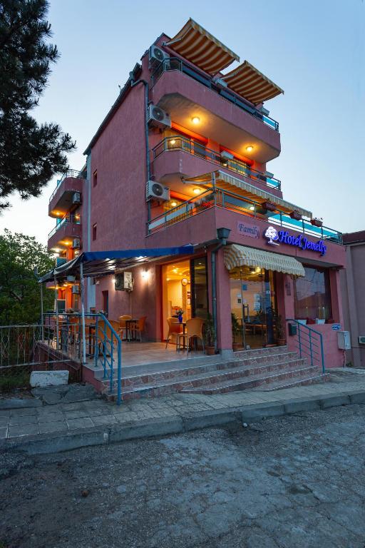 a building with a restaurant on the side of it at Family Hotel Jemelly in Obzor