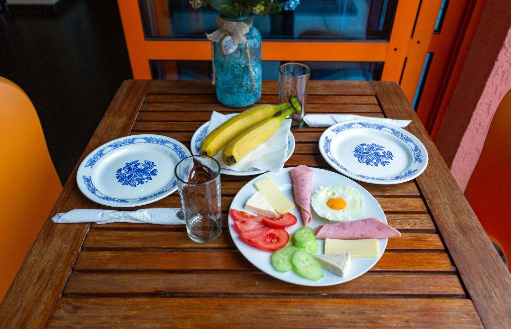 a wooden table with plates of food on it at Family Hotel Jemelly in Obzor