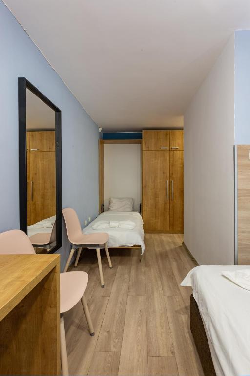 a bedroom with a bed and a desk and a chair at Family Hotel Jemelly in Obzor