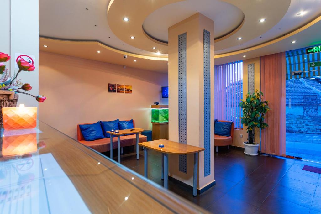 a lobby of a hotel with a table and chairs at Family Hotel Jemelly in Obzor
